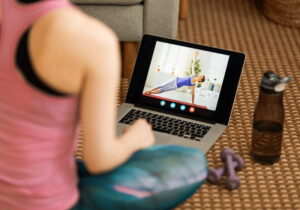 mulher vendo vídeo de exercícios em casa