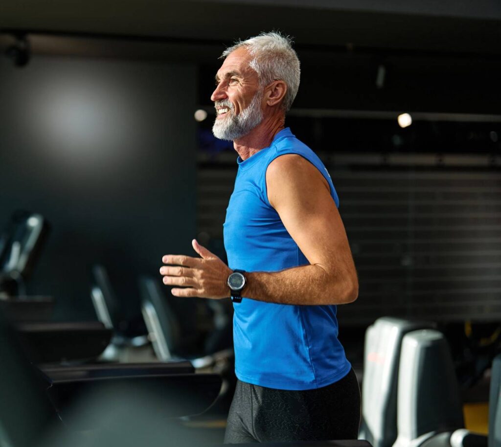 idoso praticando corrida em esteira de academia